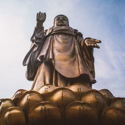 Low angle view of statue against sky