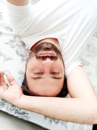 Close-up portrait of young man lying down