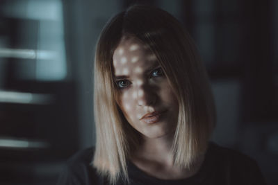 Close-up portrait of a smiling young woman at home