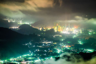 High angle view of illuminated buildings in city at night