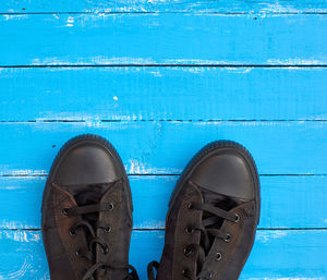 High angle view of shoes on blue wooden floor