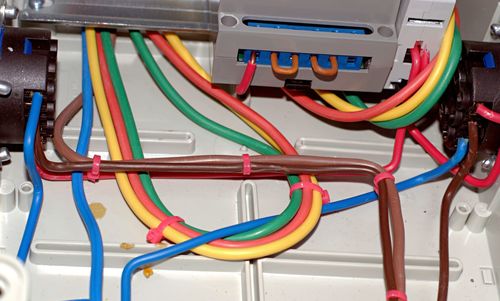 Multicolored wires are laid in the electrical panel.