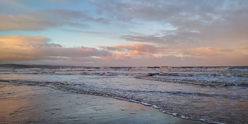 Scenic view of beach against sky during sunset