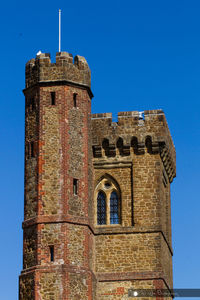 Low angle view of historical building against blue sky