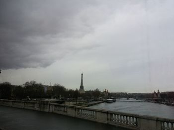 View of bridge over river against cloudy sky