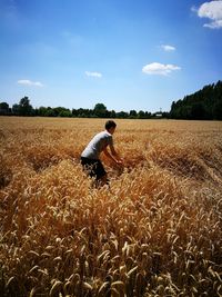 Man standing on field against sky