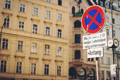 No parking sign on street against building