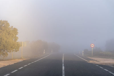 Empty road with fog at sunrise.