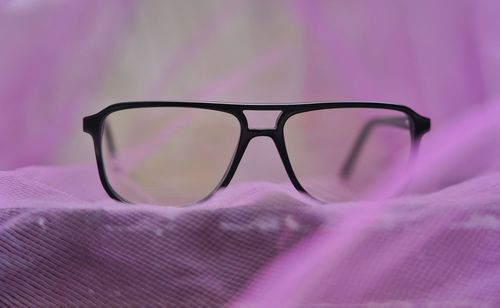 Close-up of sunglasses on pink eyeglasses