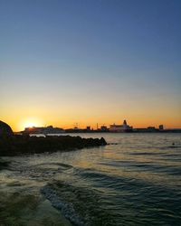 Scenic view of sea against clear sky during sunset