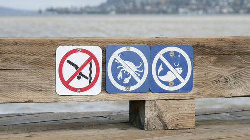 Information sign on railing against lake