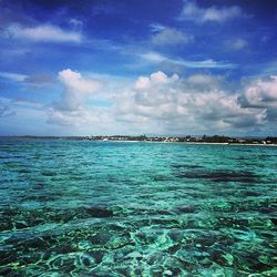 Scenic view of sea against cloudy sky