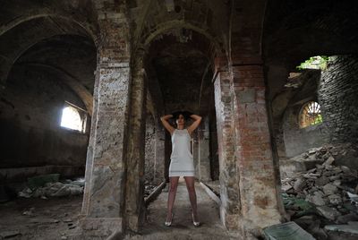 Woman standing in abandoned building