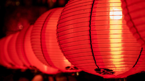 Close-up of illuminated lantern hanging in row