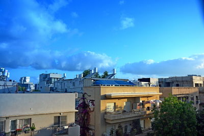 Houses and buildings against blue sky
