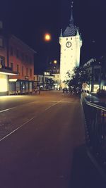 Illuminated city street at night