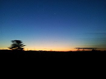 Silhouette landscape against sky at sunset