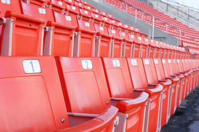 Empty orange seats at stadium,rows walkway of seat on a soccer stadium