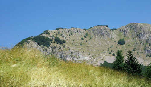 Scenic view of mountains against clear blue sky