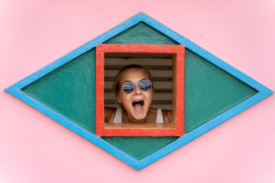 Portrait of a woman against red background