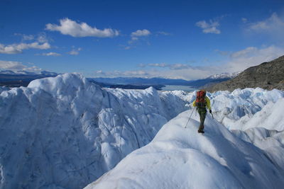 People skiing on snow covered landscape