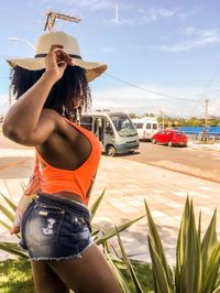 Rear view of woman in car against sky