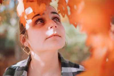 Close-up of young woman looking up