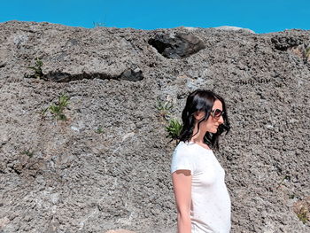 Young woman wearing sunglasses standing outdoors