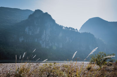 Scenic view of mountains against sky during foggy weather