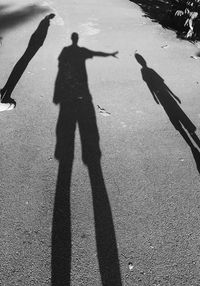 Shadow of family standing on road