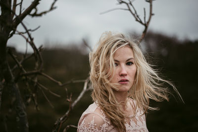 Portrait of woman against plants