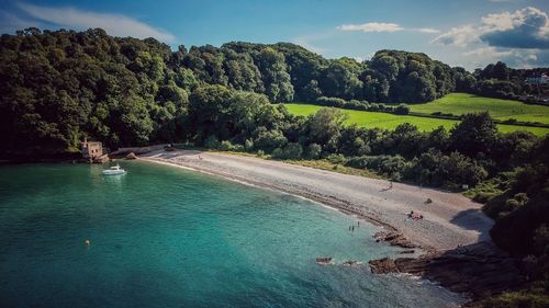 High angle view of trees by sea against sky