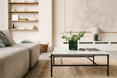 Stylish modern coffee table with metal legs and natural stone table top, modular sofa 