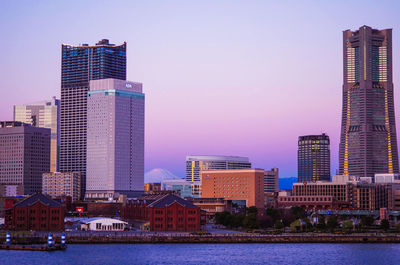 Modern buildings by the sea against sky in city