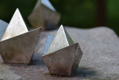 Close up of metal ships on stone 