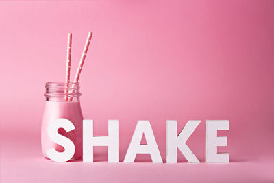Close-up of text against pink background