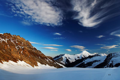 Scenic view of snow covered mountain against blue sky at swiss alps