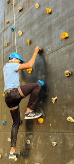 Low section of man doing rock climbing 