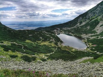 Scenic view of lake and mountains against sky