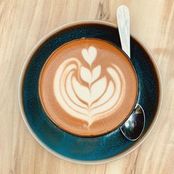 Directly above shot of cappuccino served on table