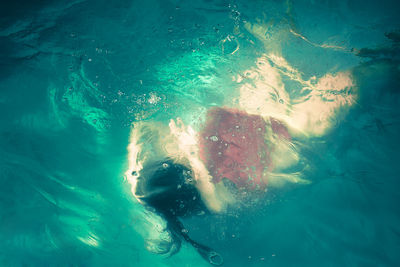 High angle view of woman swimming in sea