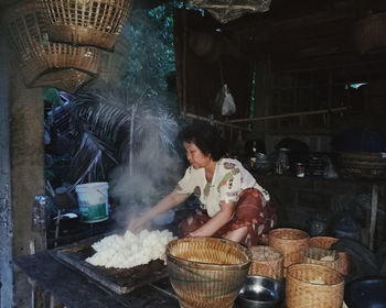 Midsection of man preparing food at market