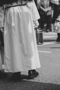 Low section of woman standing on street