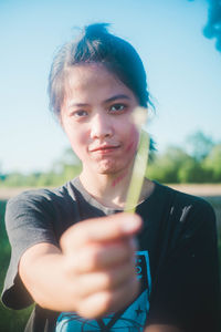 Portrait of young woman holding flower