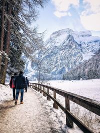 Woman standing on snow covered mountain