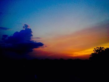 Silhouette trees against sky during sunset