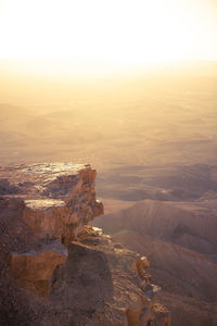 Aerial view of rock formation against sky during sunset