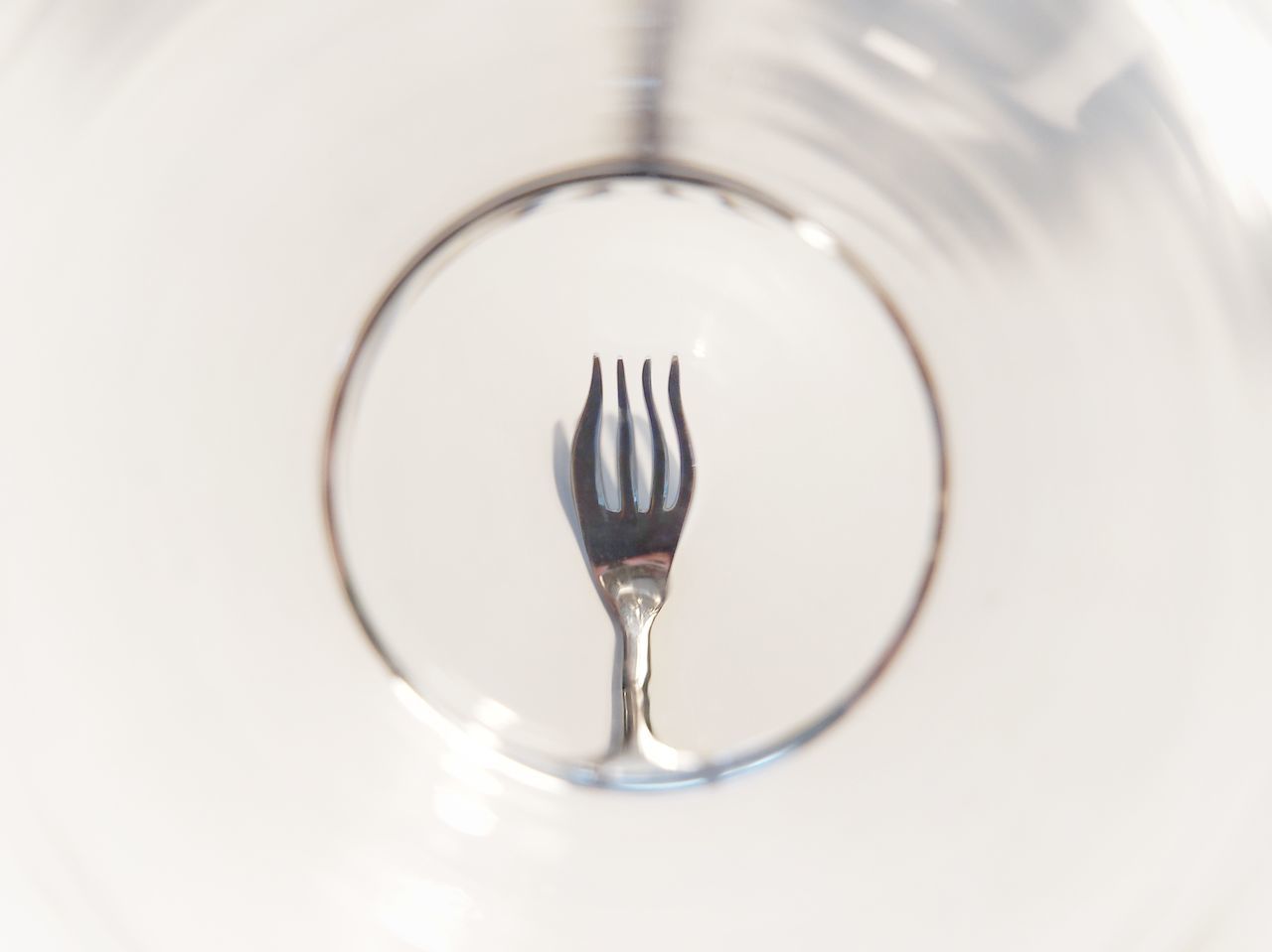 CLOSE-UP OF WINEGLASS ON GLASS