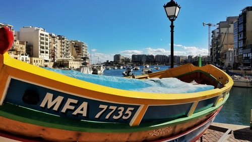 Panoramic view of boats moored in city against clear sky