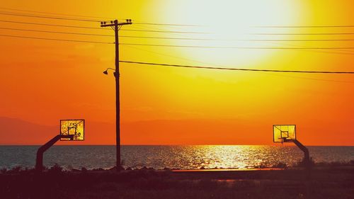 Scenic view of sea against orange sky